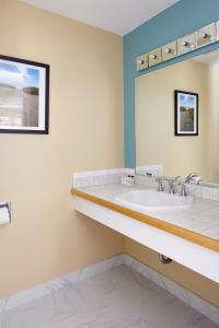 a bathroom with a sink and a mirror at Breezeway Resort in Westerly
