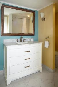 a bathroom with a white sink and a mirror at Breezeway Resort in Westerly