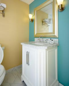 a bathroom with a sink and a mirror at Breezeway Resort in Westerly