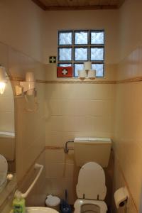 a bathroom with a toilet and a window at SigmaApartment in Zambujeira do Mar