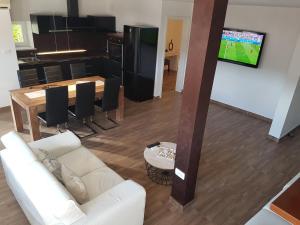 a living room with a white couch and a table at Apartment Ida in Koper