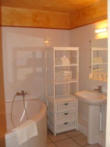 a bathroom with a bath tub and a sink at Mas De Sylvereal in Sylvéréal