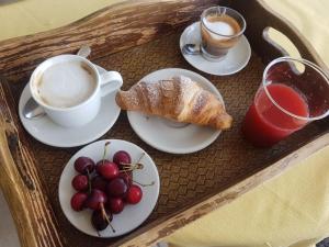 a tray with a breakfast of coffee and toast and fruit at Albergo Villa Vittoria in Rodi Garganico