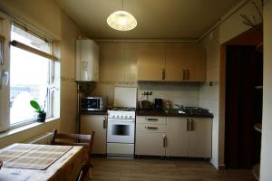 a kitchen with white appliances and a table and a window at Sunshine View in Cluj-Napoca