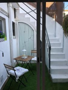 a table and chair on a patio with stairs at Vilasardemarlux2 in Vilassar de Mar