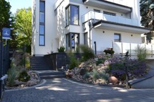 a house with a garden in front of it at Apartamenty Willa Nawigator in Gdynia