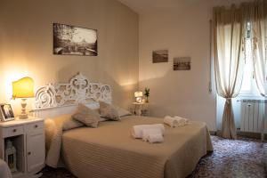 a bedroom with a bed with two towels on it at House Bonifacio in Rome