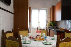 a table with plates of food on it in a kitchen at House Bonifacio in Rome