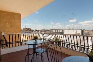 a table and chairs on a balcony with a view at Casa tua B&B in Lecce