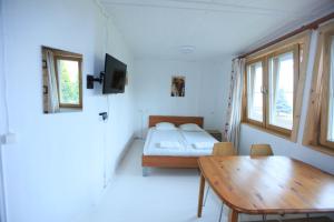 a small room with a bed and a wooden table at Vila Inga in Nida