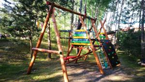 a playground with a slide and a swing set at Provincija in Palanga