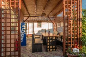 a wooden pergola with a wooden table and a table and a wooden table at Casa Ana Maria in Vama Veche