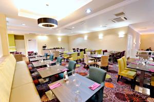 a living room filled with tables and chairs at Link Hotel in Loughborough