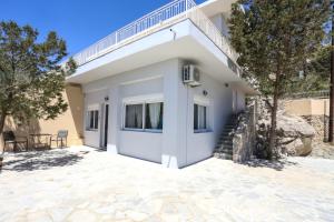 a villa with a staircase and a house at Skouros Villa in Kastrí