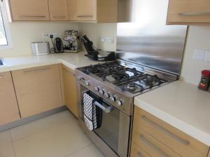 eine Küche mit einem Edelstahlherd oberen Backofen in der Unterkunft Villa Victoria in Paphos City