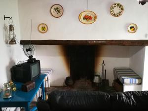 a living room with a couch and a fireplace at Monte dos Velhos in Reguengos de Monsaraz