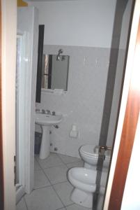 a bathroom with a toilet and a sink at Hotel Ristorante Il Calipso by Mago in Robecchetto con Induno