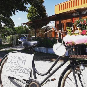 a bike with a sign on it parked on a street at La Campagnola Trattoria con Alloggio in Misano Adriatico