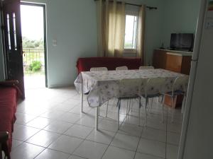 a table and chairs in a living room at Ammodares in Lixouri