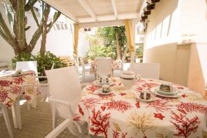 a table and chairs with a tablecloth on a patio at B&B Ghiaccio in Gallipoli +52 photos