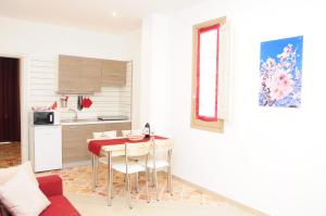 a kitchen with a table and chairs in a room at I Paesaggi in Castellammare del Golfo