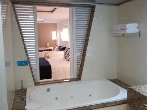 a bathroom with a tub, sink and mirror at Grand Sirenis Riviera Maya Resort & Spa All Inclusive in Akumal