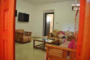 a living room with a couch and a table at Residence La Perle in Triffa