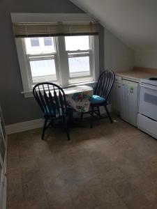 a kitchen with a table and two chairs and a window at Duplex with a View in Drumheller