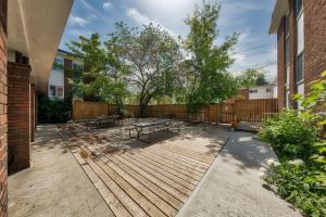 un patio con mesas de picnic y una valla en HI Edmonton - Hostel, en Edmonton