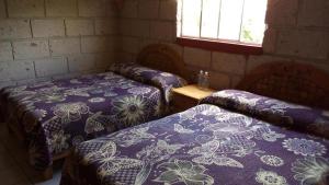 Postel nebo postele na pokoji v ubytování Hotel Mirador Real