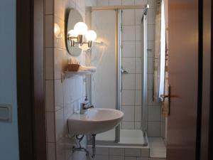 a bathroom with a sink and a shower at Restaurant Landgasthof Zum Wiesengrund in Newel +41 photos