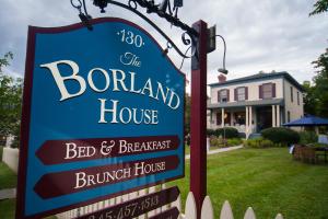 a sign for the bonnard house bed and breakfast at The Borland House Inn in Montgomery