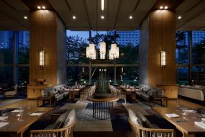 a restaurant with tables and chairs and a large window at Grand Prince Hotel Takanawa in Tokyo