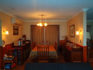 a living room with a table and a dining room at Lakefront Bellevue Lake Hawea Wanaka in Lake Hawea