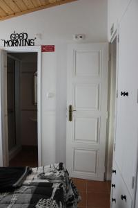 a room with a door and a bed in a room at Nest Apartment in Zambujeira do Mar