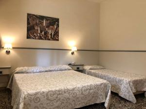 Postel nebo postele na pokoji v ubytování Hotel Ai Tufi