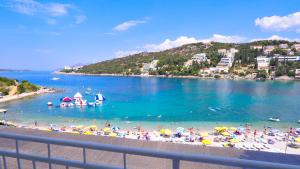 a beach with a bunch of people in the water at Hotel Vis in Dubrovnik