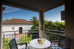 a table with a bowl of fruit on a balcony at Apartment Smuljic in Vrboska