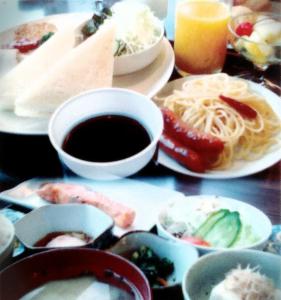 a table topped with plates of food and drinks at Matsue Plaza Hotel Annex in Matsue