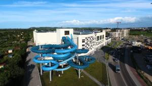 a large blue water slide in front of a building at Aquapark Reda Resort - jedyne noclegi w Aquaparku Reda in Reda