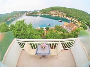 a balcony with a table and a view of a lake at Villa Ivanka in Zaton