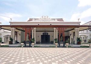 duży biały budynek z pawilonem w obiekcie Daroessalam Syariah Heritage Hotel w mieście Pasuruan