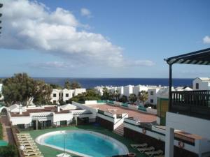 a view of a swimming pool on top of a building at Molino de Guatiza in Costa Teguise