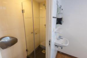 a bathroom with a shower and a sink at Travel Hotel Amsterdam in Amsterdam