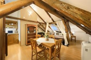 a kitchen and dining room with a table and chairs at Castle View Apartments in Český Krumlov