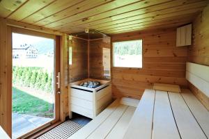 an interior of a wooden sauna with a window at Chalet Fuhrmannslochhof in Nauders
