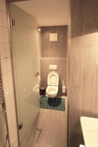 a bathroom with a toilet and two sinks in it at Ferienwohnungen „am Schlosspark Tamsweg“ im UNESCO Biosphärenpark Lungau in Tamsweg