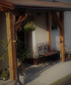 a patio with a table and a bench under a building at Apartment Rychtrovna in Hejnice