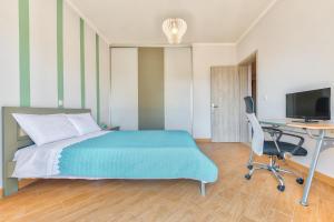 a bedroom with a bed and a desk and a computer at Villa Penelope in Kalpaki +13 photos