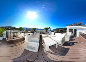 a patio with white chairs and tables on a building at Wellness & Spa Hotel ACD Annex in Herceg-Novi
